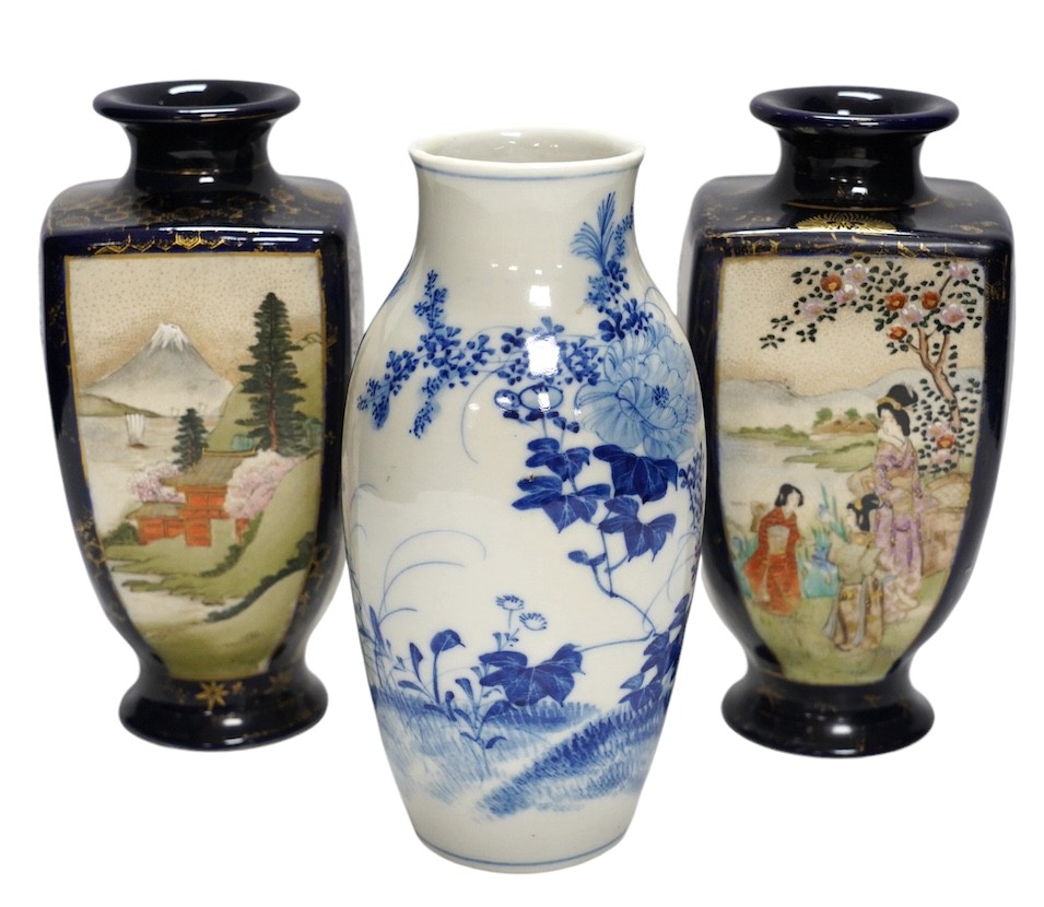 A pair of Japanese satsuma pottery vases and a blue and white Meiji Arita vase, largest 24cm high. Condition - fair